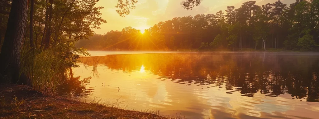 a vibrant sunset casts a warm golden glow over a tranquil lake, where the mirrored reflections of towering trees create a serene and captivating atmosphere.